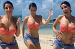 Nora Fatehis dance moves only get stylishly better by the beach in a pink swim set, denim shorts